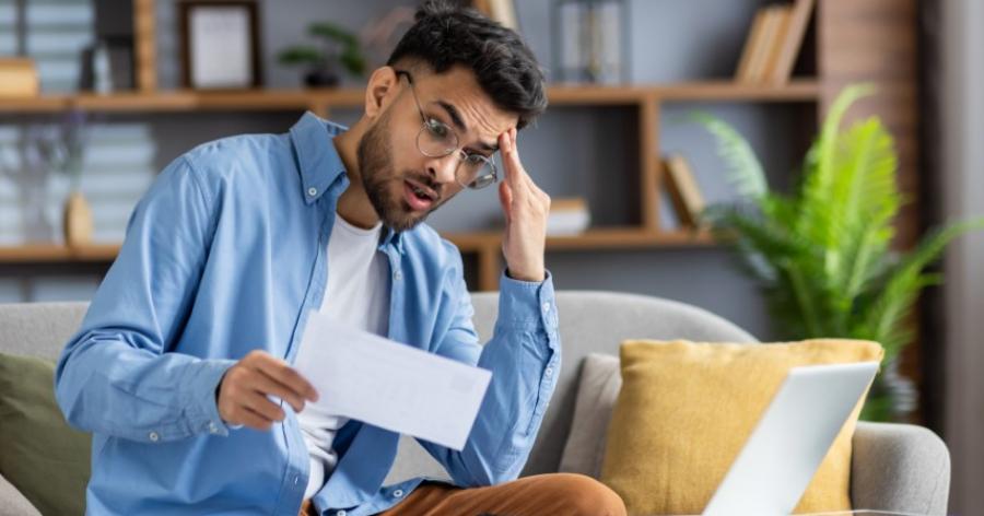 stressed man looking at documents